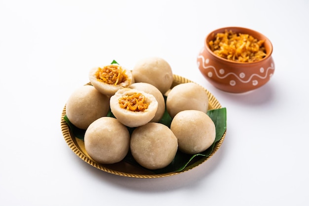 Photo kozhukatta or kolukattai pidi is steamed dumplings made with rice flour filling coconut jaggery