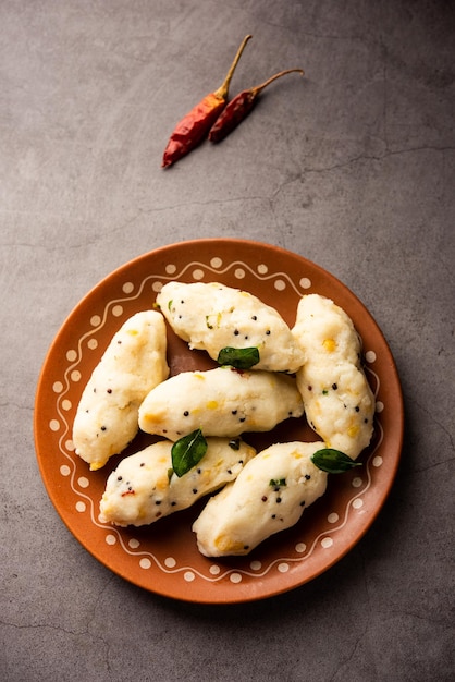 Photo kozhukatta pidi is a steamed snack food from kerala rice flour with finger impressions