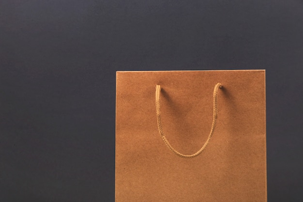 Photo kraft paper bag on bright dark surface.