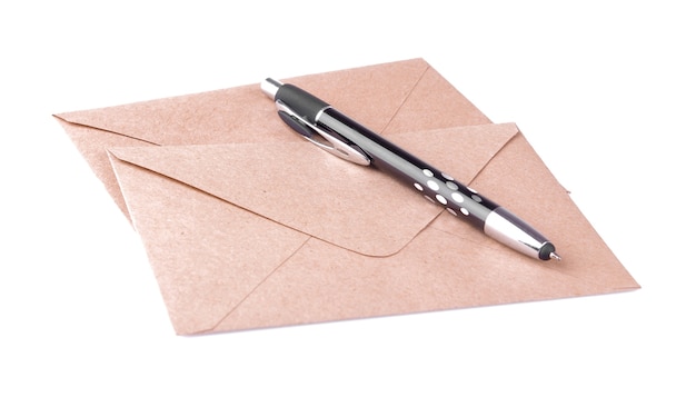 Kraft paper envelopes and a pen on a white isolated background. mail concept