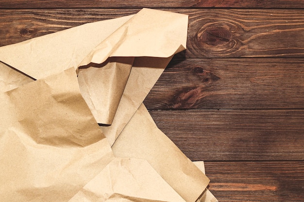 Kraft paper for packing parcels on a wooden background