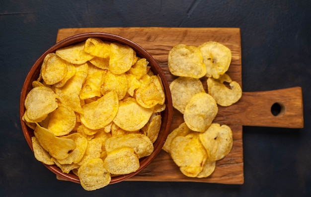 Krokante chips in een kom op een stenen achtergrond