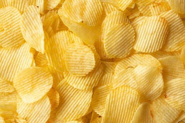 Krokante gouden chips snack textuur achtergrond