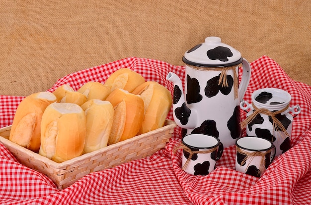 Foto kruik koffie en melk met mand brood