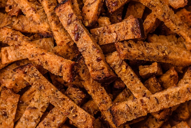 Kruisende zelfgemaakte bruine broodcrackers of croutons met zaden en granen