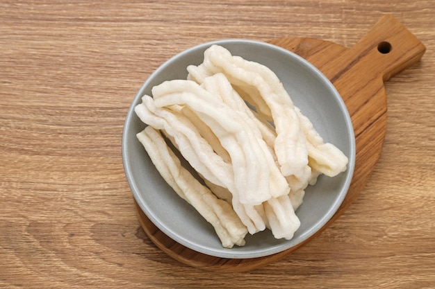 Krupuk or Kerupuk Indonesia traditional crackers served on bowl on wooden background