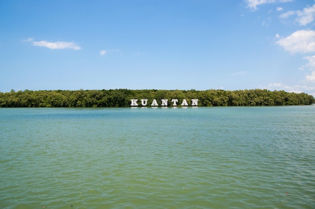 Kuantanteken op rivier in Maleisië. Rivierwater en groene kust op blauwe hemel. Zomervakantie. Ontdekking en avontuur. Wanderlust en reizen concept.