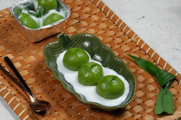 kue putri mandi or badak berendam Are Steamed glutinous rice balls filled with coconut brown sugar