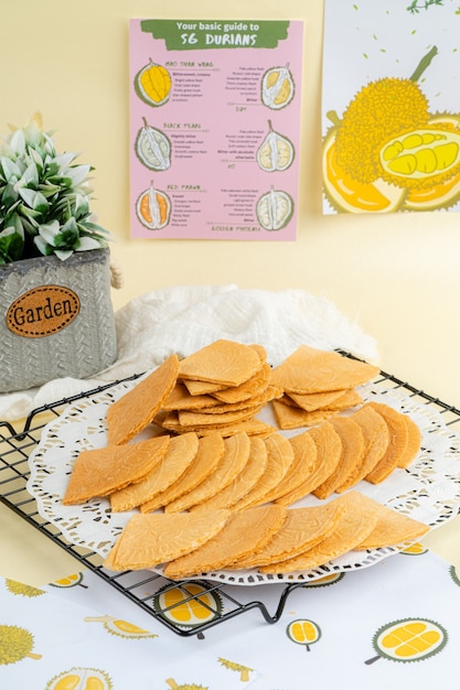 Kue semprong is an Indonesian traditional wafer snack made by clasping egg batter using an iron mold