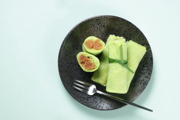 Kuih Ketayap in Malaysia or Dadar Gulung in Indonesia is a Roll Crepes Filled with Grated Coconut