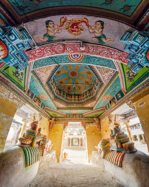 KUMBAKONAM, INDIA - September 4, 2018 : Statues of riders on elephants and painted ornaments on the walls of the temple Nageshwara (Nageswaraswamy)