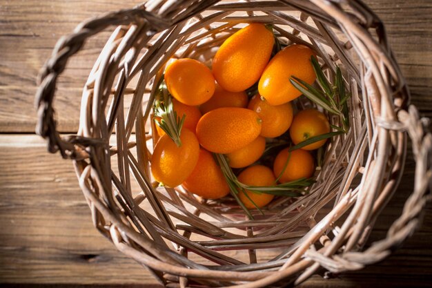 Kumquat berries on wooden background citrus fruit ingredient food