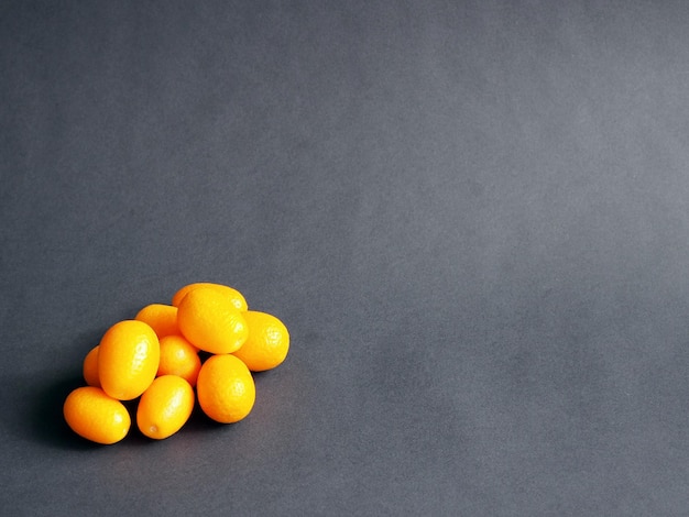 Kumquat on black background