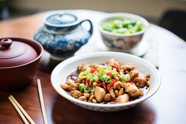 Photo kung pao chicken beside a bowl of soy sauce