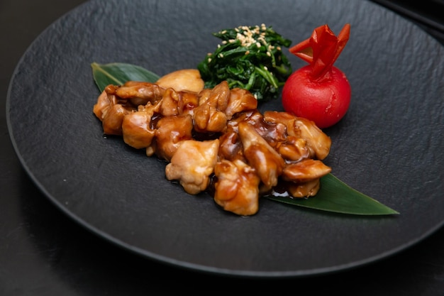 Kung Pao Chicken or Gong Bao Ji Ding at dark slate background Sichuan Kung Pao is chinese cuisine dish with chicken meat chilli peppers peanuts sauces and onion