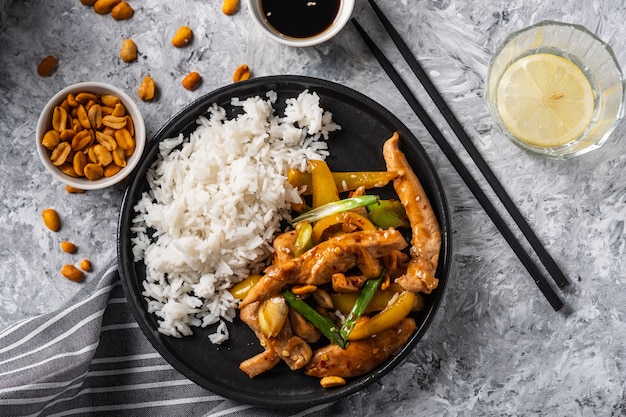 Kung Pao chicken, stir-fried Chinese sichuan traditional sichuan  dish with chicken, peanuts, vegetables and chili peppers.