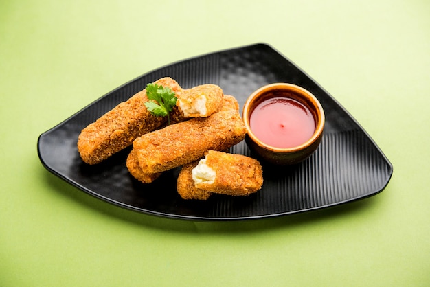 Kurkuri paneer fingers of pakora, pakoda snacks ook wel bekend als Crispy Cottage Cheese Bars, geserveerd met tomatenketchup als voorgerecht. selectieve focus