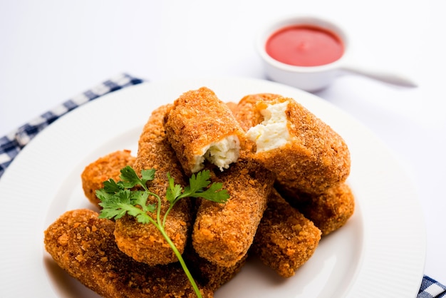 Kurkuri paneer fingers or pakora, pakoda snacks also known as Crispy Cottage Cheese Bars, served with tomato ketchup as a starter. selective focus