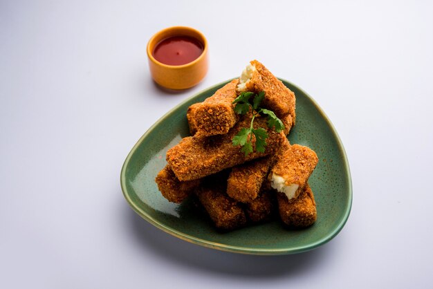 Kurkuri paneer fingers or pakora, pakoda snacks also known as Crispy Cottage Cheese Bars, served with tomato ketchup as a starter. selective focus