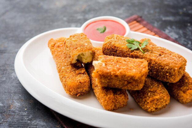 Kurkuri paneer fingers or pakora, pakoda snacks also known as Crispy Cottage Cheese Bars, served with tomato ketchup as a starter. selective focus