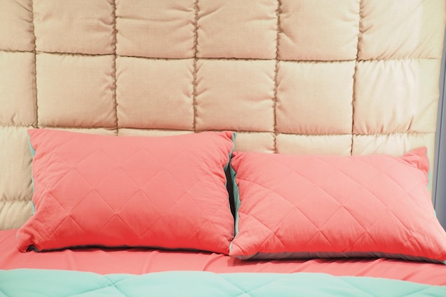 Kussen in roze kleur op bed