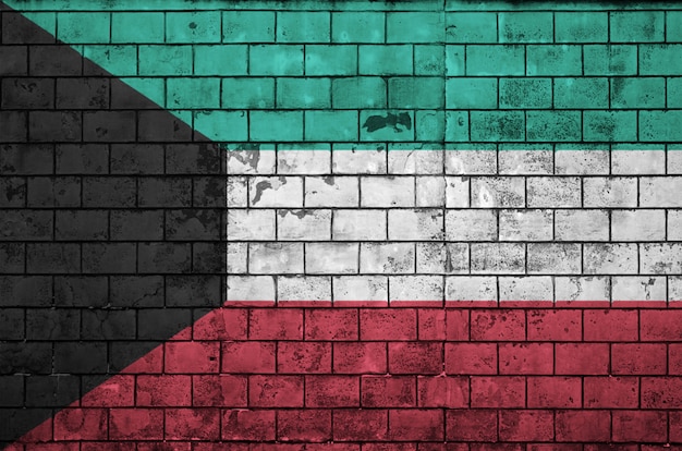 Kuwait flag is painted onto an old brick wall