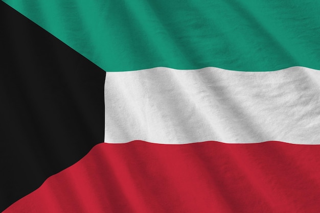 Kuwait flag with big folds waving close up under the studio light indoors The official symbols and colors in banner