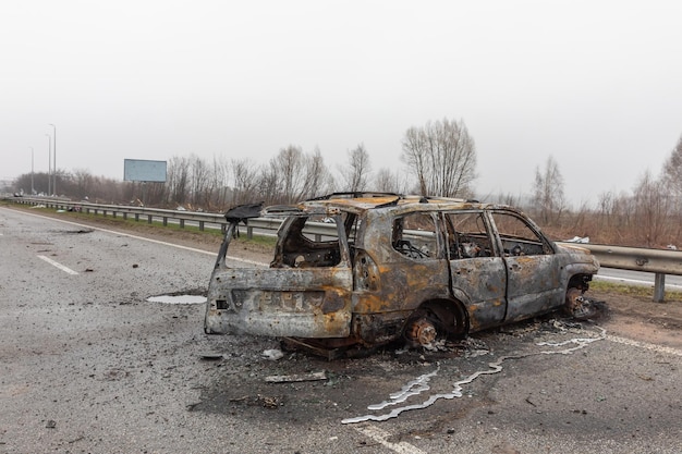 KYIV REG UKRAINE Apr 02 2022 A destroyed and burnt cars seen on a KyivZhytomyr highway 20 km from Kyiv