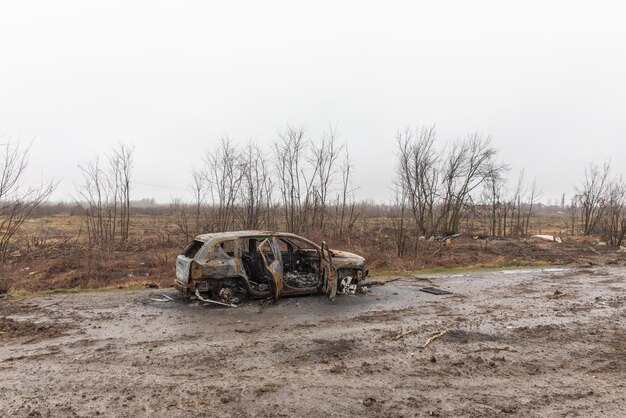 KYIV REG UKRAINE Apr 02 2022 A destroyed and burnt cars seen on a KyivZhytomyr highway 20 km from Kyiv