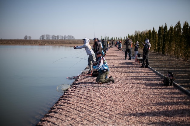 KYIV, UKRAINE - APRIL 16, 2018 Sport fishing tournament, male fishermen catch fish in the lake