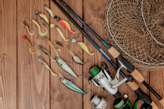 Kyiv Ukraine May 15 2019 Fishing tackle fishing spinning hooks and lures on wooden background with copy space