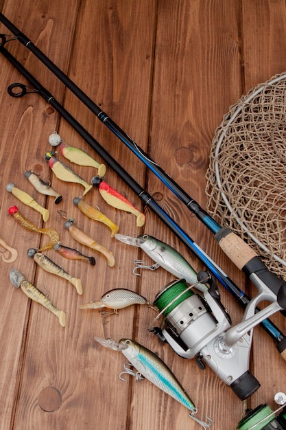 Kyiv Ukraine May 15 2019 Fishing tackle fishing spinning hooks and lures on wooden background with copy space