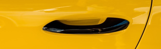 Kyiv ukraine october 7 2019 panoramic shot of car handle in luxury yellow porshe