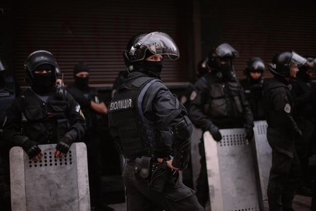 Kyiv, ukraine, september 18, 2018 protesters storm a public\
facility. policemen with riot shields.