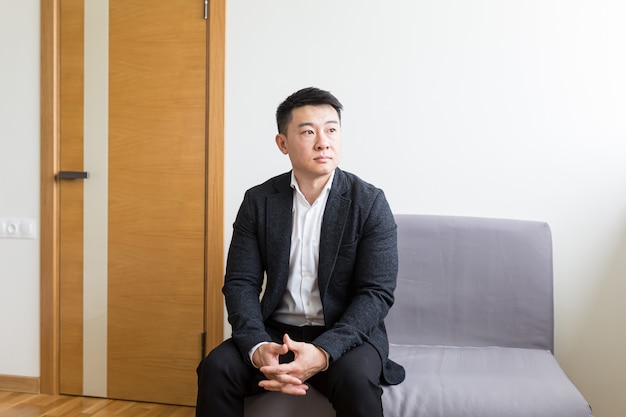 l asian man waiting for a job interview in the waiting room of the office center