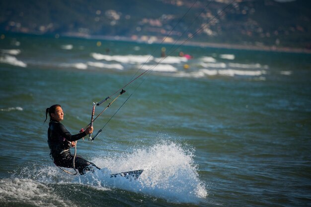 L'ESTARTIT, SPAIN - AUGUST 8 2021: A woman rides a kite.