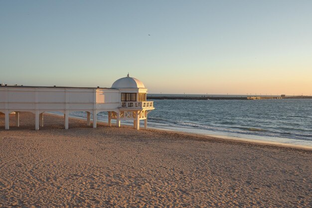 La Caleta Beach and Balneario de la Palma Building at sunset Cadiz Andalusia Spain