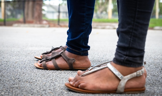 Laag gedeelte van de man die schoenen draagt en op het voetpad staat