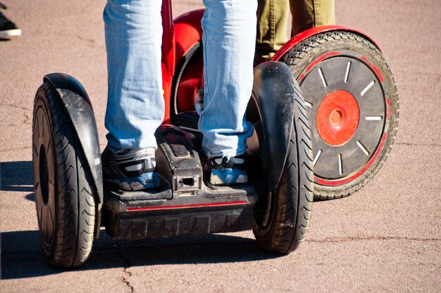 Foto laag gedeelte van een man die op een segway staat op straat