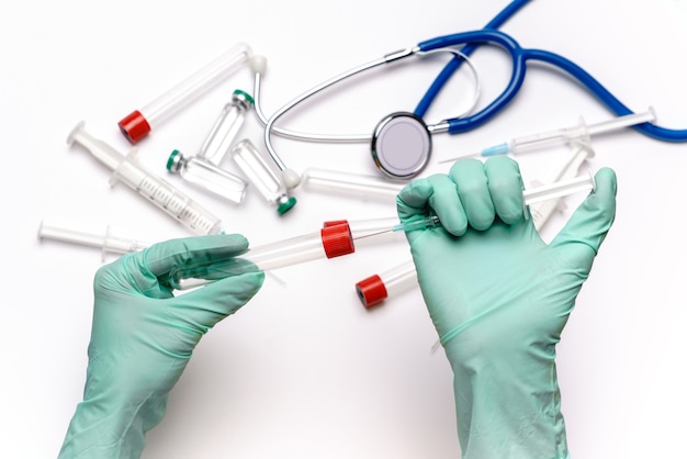 Lab technician assistant holding syringe and test tube over light grey or white background