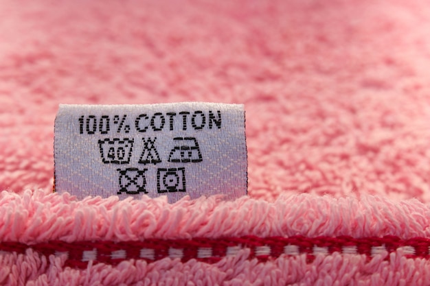 Label 100% cotton on pink towel