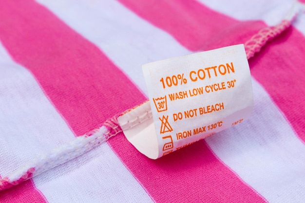 Label 100 cotton on a pink and white tshirt