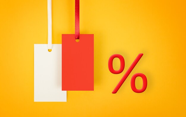 labels and percent sign on yellow background concept of discounts and sales with copy space