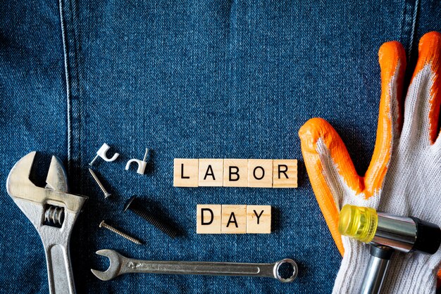 Labor day concept, Different kinds on wrenches, handy tools on blue jeans background.