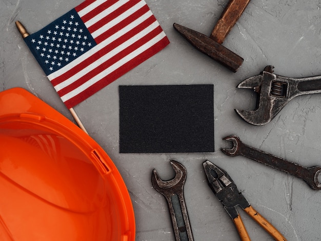 Photo labor day. hand tools and the flag of the united states of america lying on the table. view from above, close-up. congratulations to family, relatives, friends and colleagues. national holiday concept