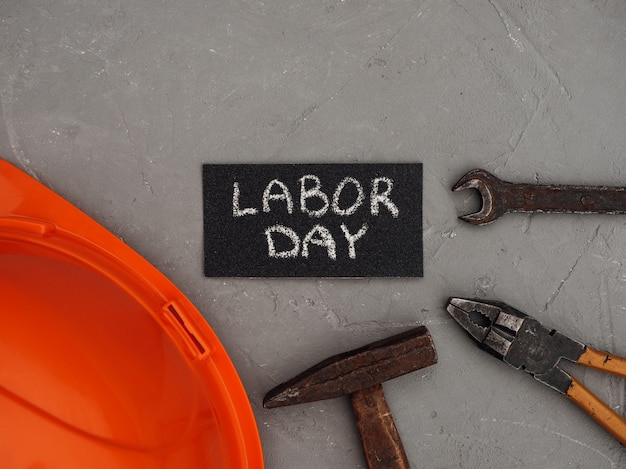 LABOR DAY. Hand tools lying on the table. View from above, close-up. Preparing for the celebration. Congratulations to loved ones, family, relatives, friends and colleagues. National holiday concept