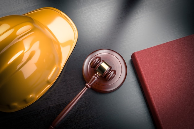 Labor law in construction industry business concept - yellow hardhat helmet, gavel, law books on table - 3d render