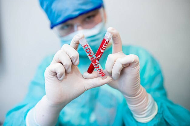 laboratory assistant holds test tubes with coronavirus vaccine in his hand blood test