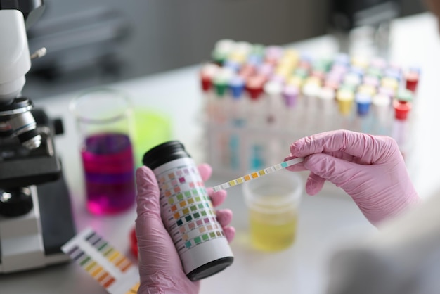 Photo laboratory assistant making medical test using testing strip