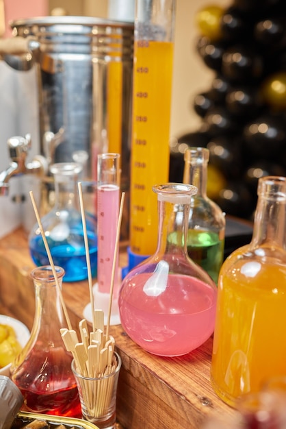 Laboratory glassware with alcohol cocktail's on chemical party